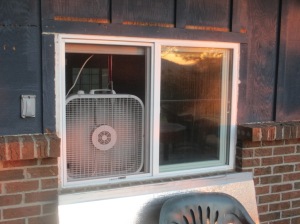 A box fan in the same window.  I open all the windows and run this fan overnight, then turn off the fan, close the windows and cover them with insulation when I get up in the morning.  I usually train within an hour or two of waking up, so I leave everything sealed throughout the workout.